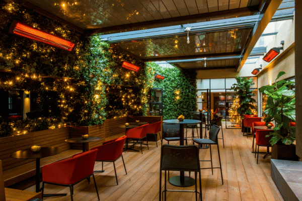 stylish outdoor seating area at a restaurant, featuring Bromic wall mounted heaters.
