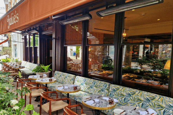 outdoor seating area outside a cafe bar, featuring Bromic wall mounted heaters.